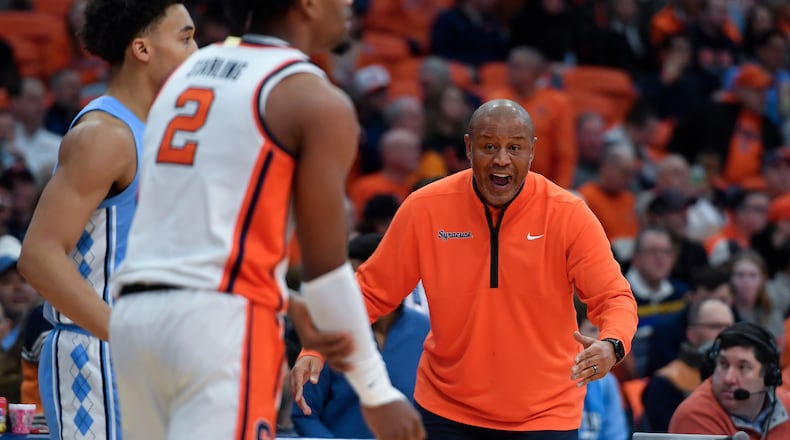 Syracuse head coach Adrian Autry, right, yells instructions to guard J.J. Starling (2) during the first half of an NCAA college basketball game against North Carolina, Saturday, Feb. 21, 2026, in Syracuse, N.Y. (AP Photo/Adrian Kraus)
