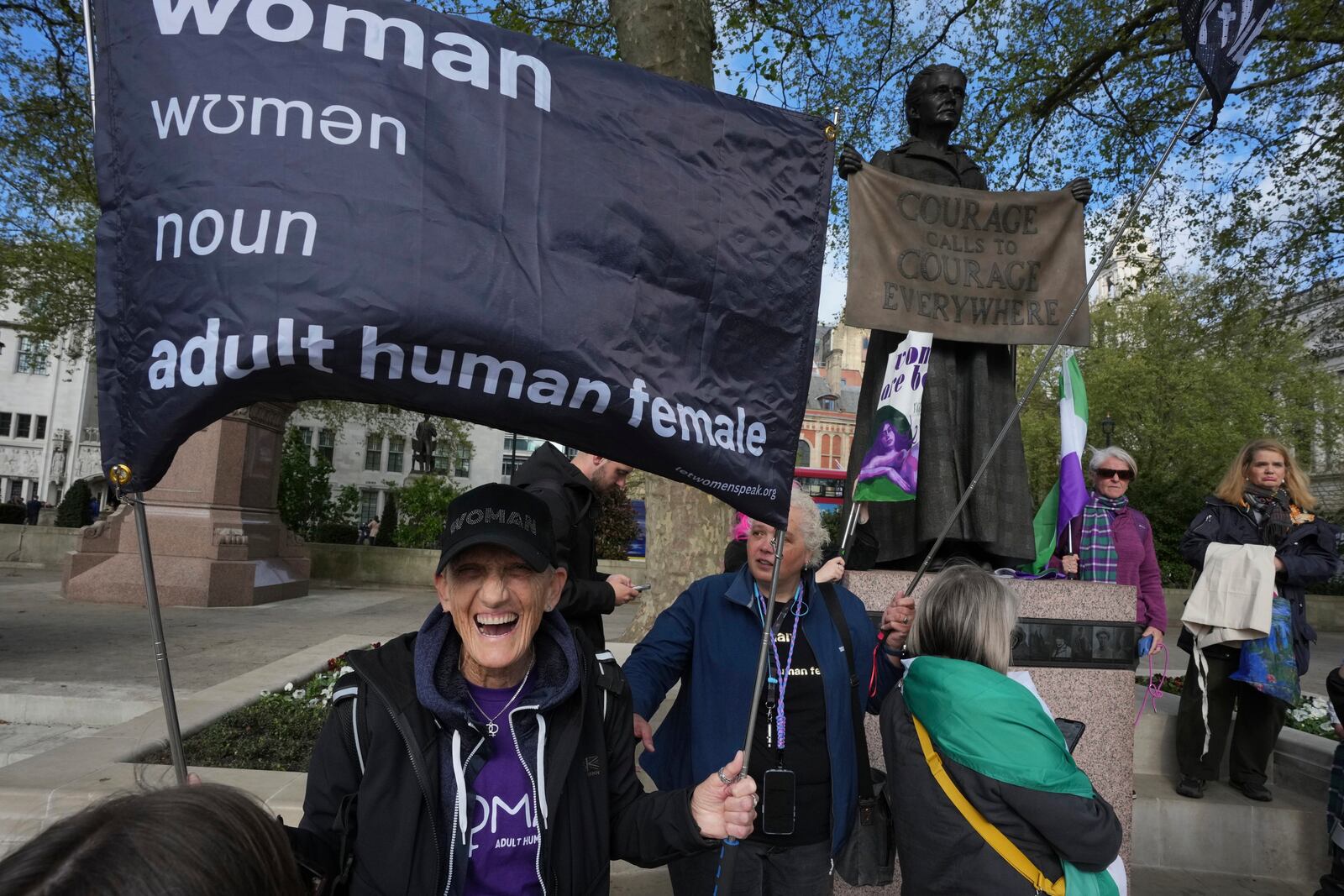 Women's rights activists hold placards outside the Supreme Court to challenge gender recognition laws, in London, Wednesday, April 16, 2025. (AP Photo/Kin Cheung)