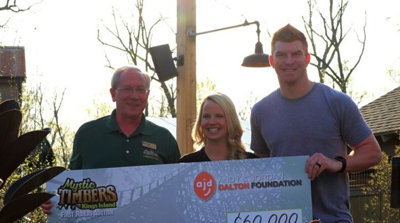 Mike Koontz, Kings Island vice president and GM, presents a check to Jordan and Andy Dalton on Thursday night, April 13, 2017, at Kings Island. (Courtesy/Kings Island)