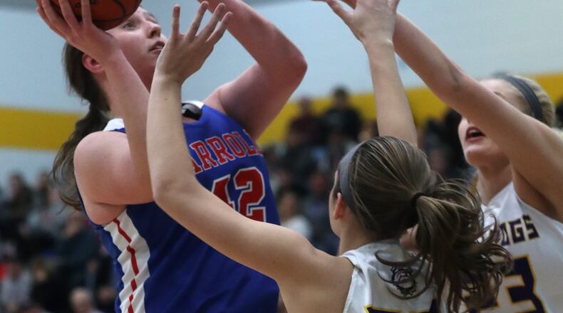 Carroll’s Julia Keller puts up a shot under pressure from two Bloom-Carroll defenders during the Regional semi-final game. BILL LACKEY/STAFF