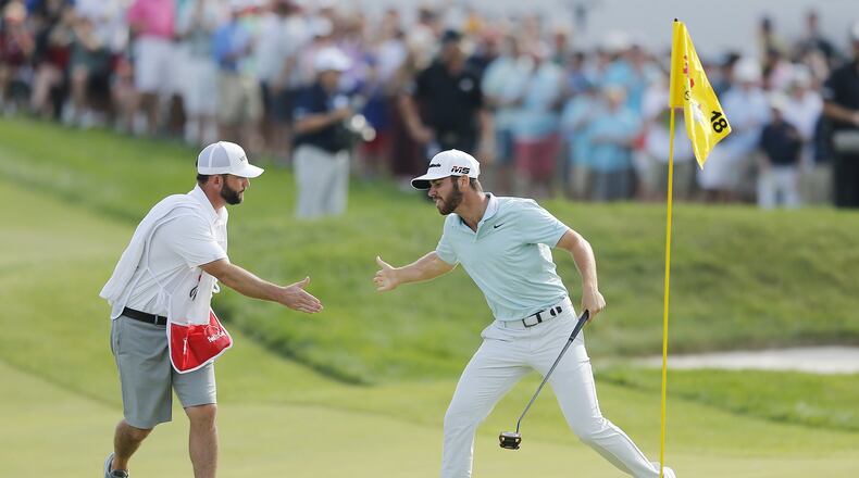 BLAINE, MINNESOTA - JULY 07: Matthew Wolff of the United States celebrates with his caddie, Steve Lohmeyer, after making a eagle putt on the 18th green to win the 3M Open at TPC Twin Cities on July 07, 2019 in Blaine, Minnesota. (Photo by Michael Reaves/Getty Images)