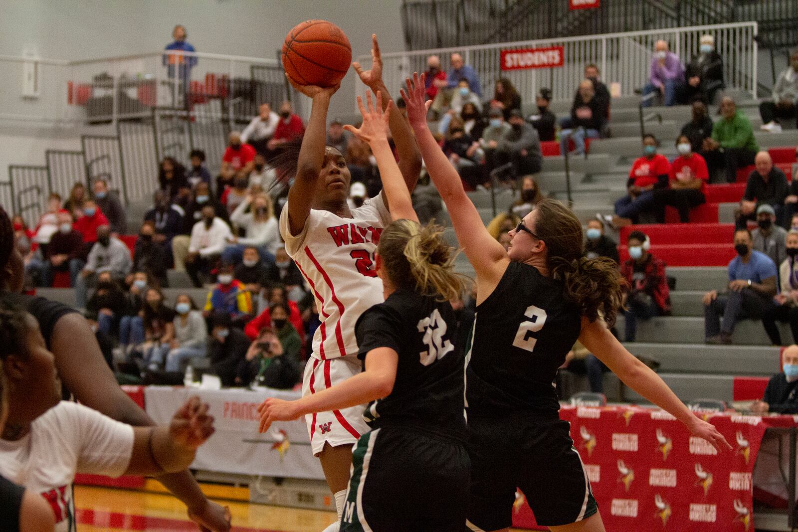 Wayne's Bree Hall shoots over Mason's Margo Mattes (32) and Kate Cooper during the Warriors 55-51 win over Mason. Hall scored 25 points. Jeff Gilbert/CONTRIBUTED