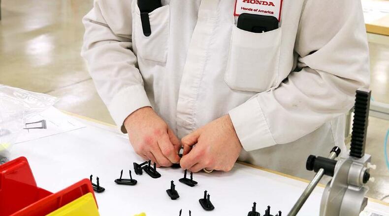 A Honda employee in Marysville works on ventilator parts. Honda photo.