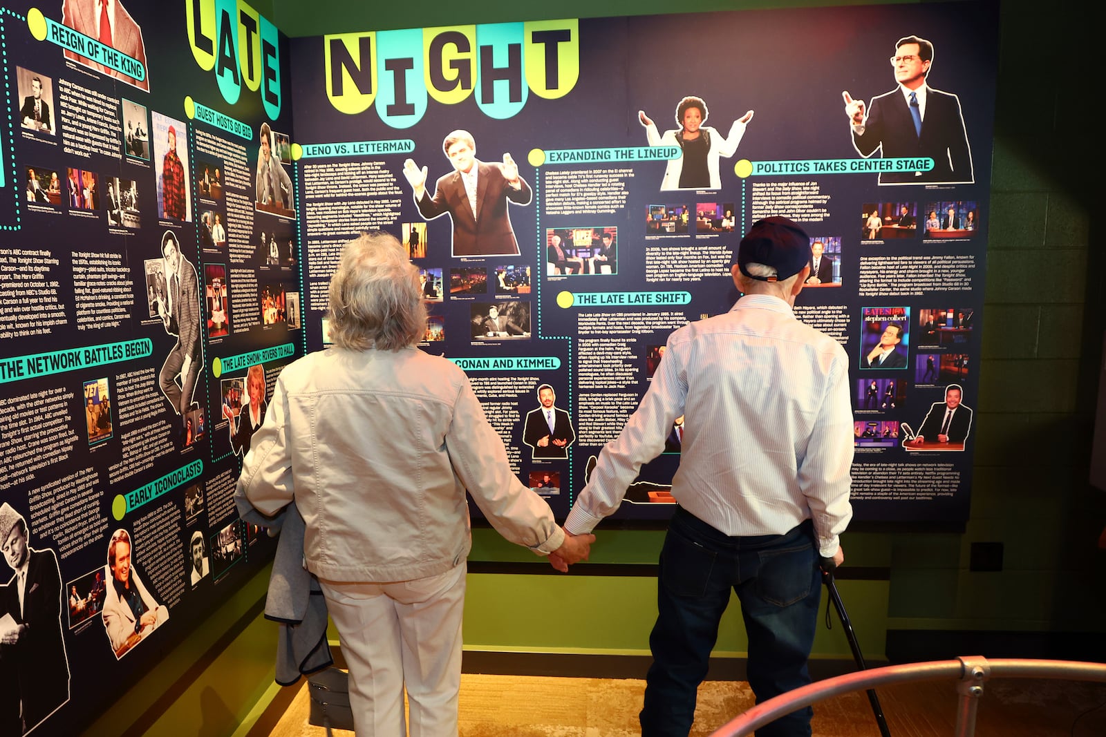 Mario and Gail Cirasunda, of Orchard Park, N.Y., look at exhibits from past and current comedy stars on display during a Memory Cafe event at the National Comedy Center Monday, May 5, 2025, in Jamestown, N.Y. (AP Photo/Jeffrey T. Barnes)