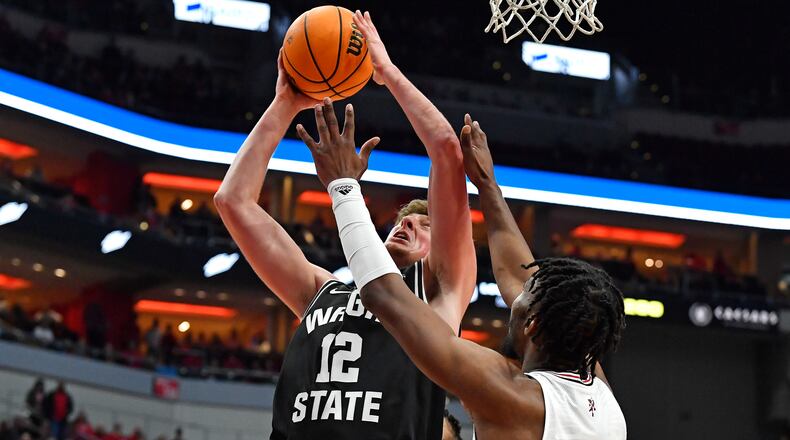Wright State center AJ Braun (12) shoots over the defense of Louisville forward Jae'Lyn Withers (24) during the first half of an NCAA college basketball game in Louisville, Ky., Saturday, Nov. 12, 2022. (AP Photo/Timothy D. Easley)