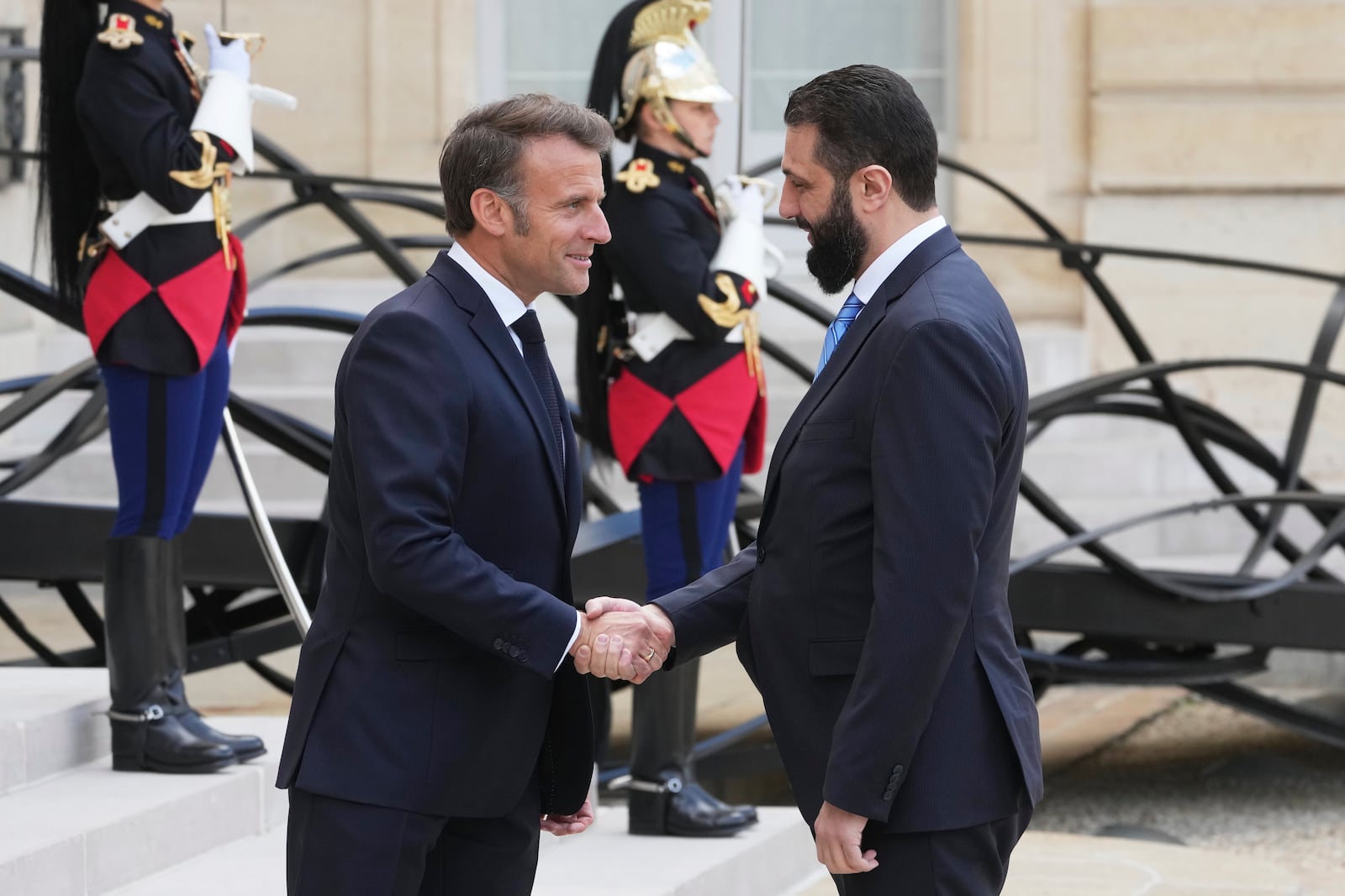 French President Emmanuel Macron, left, shakes hands with Syria's interim President Ahmad al-Sharaa before their talks Wednesday, May 7, 2025 at the Elysee Palace in Paris. (AP Photo/Michel Euler)