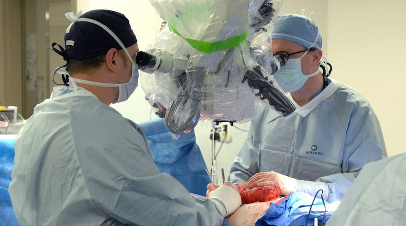 Maj. (Dr.) Nickolay Markov and Lt. Col. (Dr.) Justin Fox perform a microsurgical procedure using a surgical microscope at Wright-Patterson Medical Center. (U.S. Air Force photo/Kristen Van Wert)