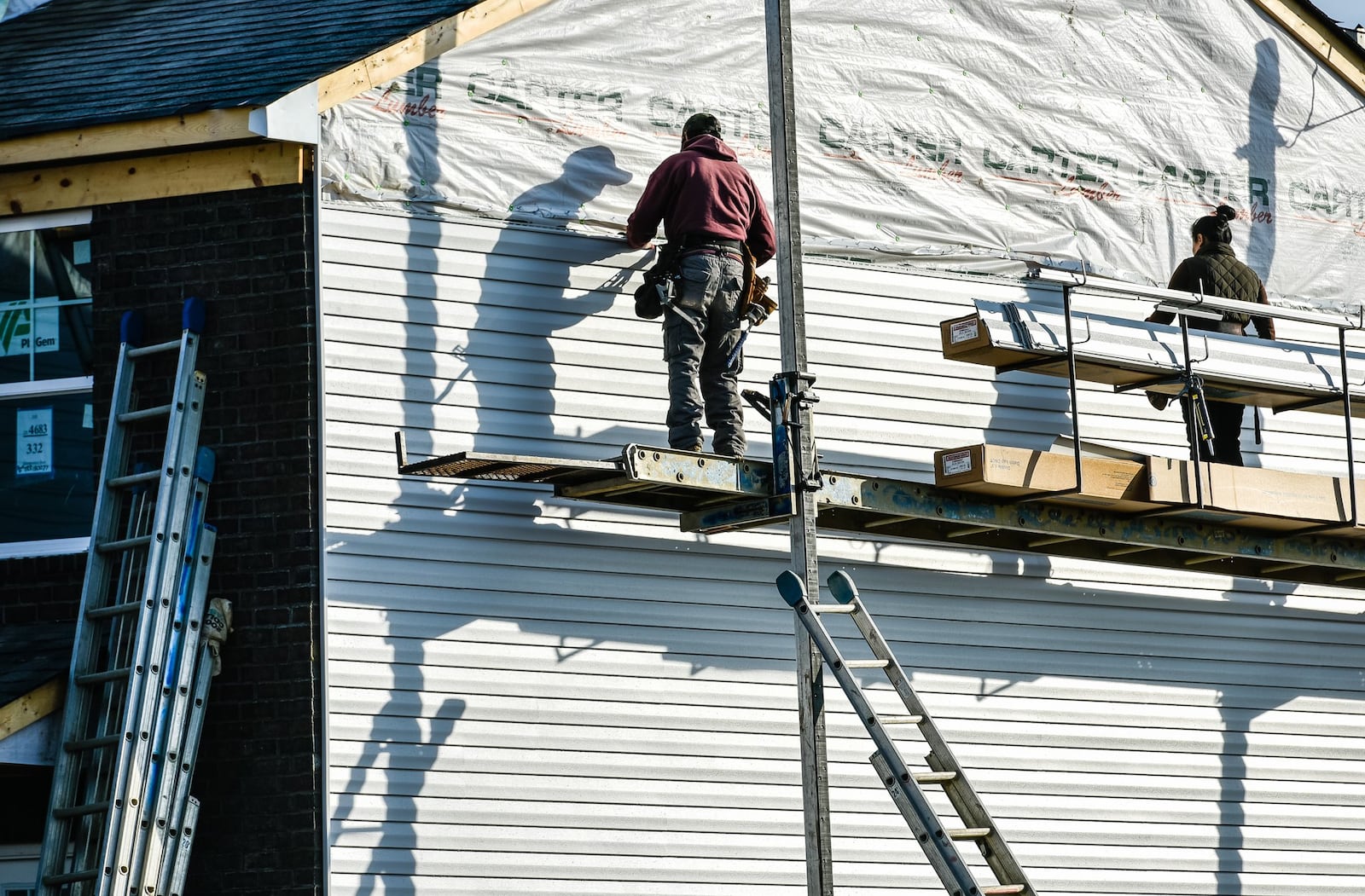 FILE: Construction crews install siding on a house being built by Cristo Homes on Governors Avenue Feb. 21, 2019, in Trenton. NICK GRAHAM/STAFF