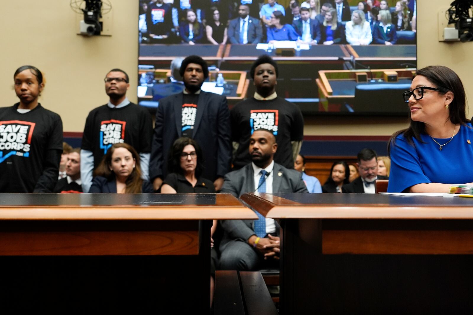Secretary of Labor Lori Chavez-DeRemer looks as Job Corps members stand behind her during a House Education and Workforce hearing, Thursday, June 5, 2025, on Capitol Hill in Washington. (AP Photo/Julia Demaree Nikhinson)