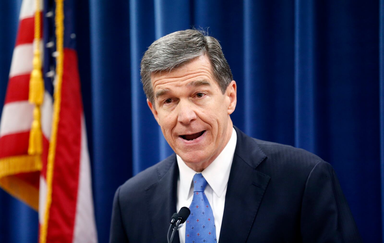 FILE - In this Dec. 15, 2016 file photo, North Carolina's Governor-elect Roy Cooper holds a press conference to criticize efforts by Republicans to cut the power of the governor's office during the special session of the General Assembly that is going on a few blocks away  in Raleigh, N.C. North Carolina's incoming Democratic governor has sued over a new law passed by Republican legislators to limit his powers as he prepares to take office. Cooper filed the lawsuit Friday, Dec. 30 over the law that ends the control governors exert over statewide and county election boards.  (Chris Seward  /The News & Observer via AP, File)