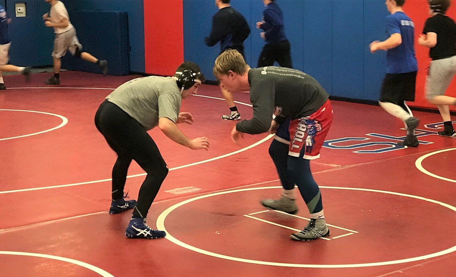Jefferson Bishop (right) squares off with a teammate during a recent Carroll High School wrestling practice. Tom Archdeacon/STAFF