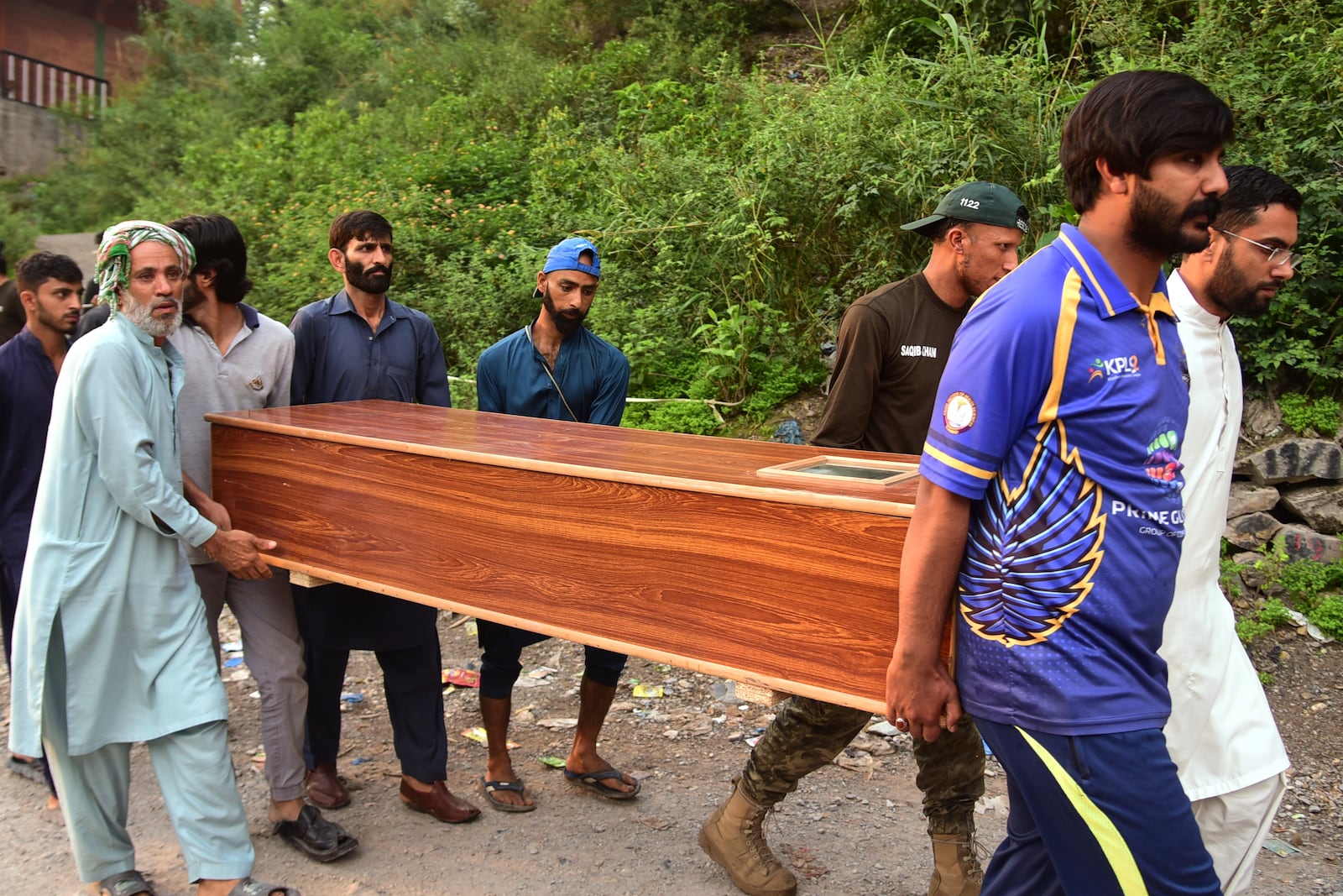 Volunteers carry a body after recovering it from the rubble of a mosque building damaged by a suspected Indian missile attack near Muzaffarabad, the capital of Pakistan controlled Kashmir, on Wednesday, May 7, 2025. (AP Photo/M.D. Mughal)