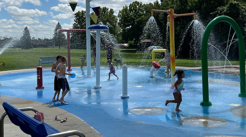 Visitors to Thomas Cloud Park cool off in the splash pad on Saturday. AIMEE HANCOCK/STAFF