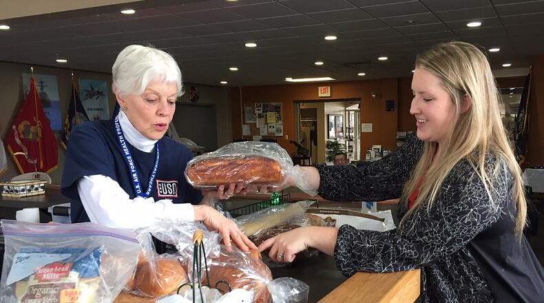 Volunteer Tosca Hallock (left), and USO Center Manager Whitney Armstrong sort free bread for visitors inside Bldg. 1222, Kittyhawk Center, Area A, Wright-Patterson Air Force Base. (Skywrighter photo/Amy Rollins)