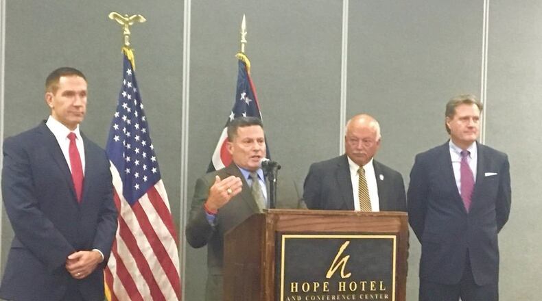 From left to right, State Rep. Jim Butler, State Rep. Rick Perales, State Sen. Bob Hackett and U.S. Rep. Mike Turner speak during a press conference on Tuesday about a bill introduced in the Statehouse this week. The bill would streamline the process for spouses of military members to transfer their professional licensure or certificates to Ohio.
