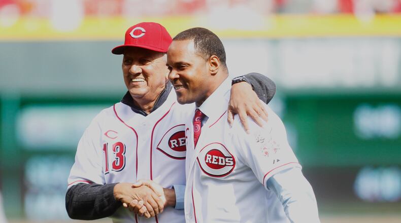 Reds legends Dave Concepcion and Barry Larkin shake hands after throwing out the first pitches against the Cardinals on Opening Day at Great American Ball Park on Monday, March 31, 2014, in Cincinnati. David Jablonski/Staff