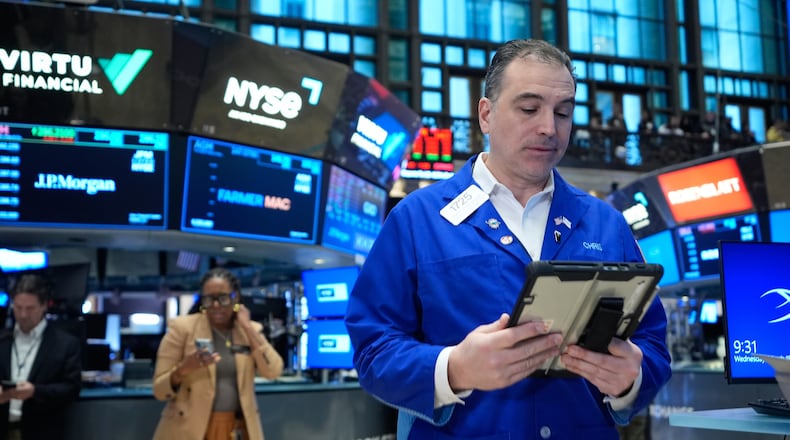 Christopher Lagana works on the floor at the New York Stock Exchange in New York, Wednesday, March 18, 2026. (AP Photo/Seth Wenig)
