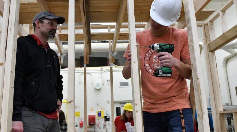Jim Kitchen, left, watches Tippecanoe High School student work on tiny house to be donated to veterans project. CONTRIBUTED