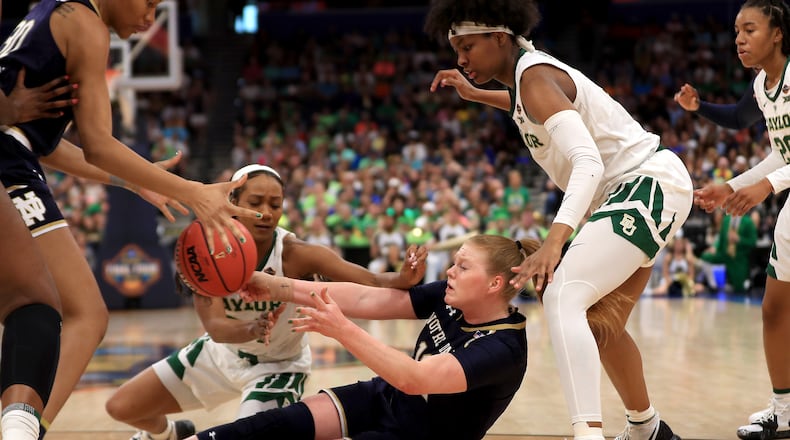 TAMPA, FLORIDA - APRIL 07: Abby Prohaska #12 of the Notre Dame Fighting Irish attempts to pass the ball to teammate Mikayla Vaughn #30 against the Baylor Lady Bears during the second quarter in the championship game of the 2019 NCAA Women's Final Four at Amalie Arena on April 07, 2019 in Tampa, Florida. (Photo by Mike Ehrmann/Getty Images)