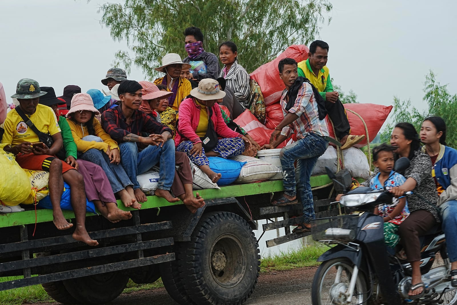 Cambodians sit on a cart of a tractor as they take refuge in Oddar Meanchey province, Cambodia, Saturday, July 26, 2025. (AP Photo/Heng Sinith)