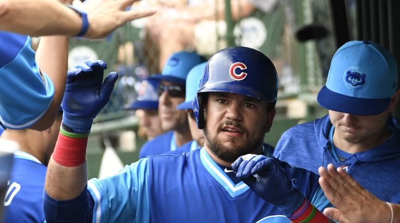 CHICAGO, IL - AUGUST 25: Kyle Schwarber #12 of the Chicago Cubs is greeted after scoring against the Cincinnati Reds during the second inning on August 25, 2018 at Wrigley Field in Chicago, Illinois. (Photo by David Banks/Getty Images)