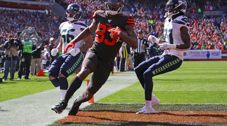 CLEVELAND, OHIO - OCTOBER 13: Ricky Seals-Jones #83 of the Cleveland Browns scores a second quarter touchdown next to Tre Flowers #21 of the Seattle Seahawks at FirstEnergy Stadium on October 13, 2019 in Cleveland, Ohio. (Photo by Gregory Shamus/Getty Images)