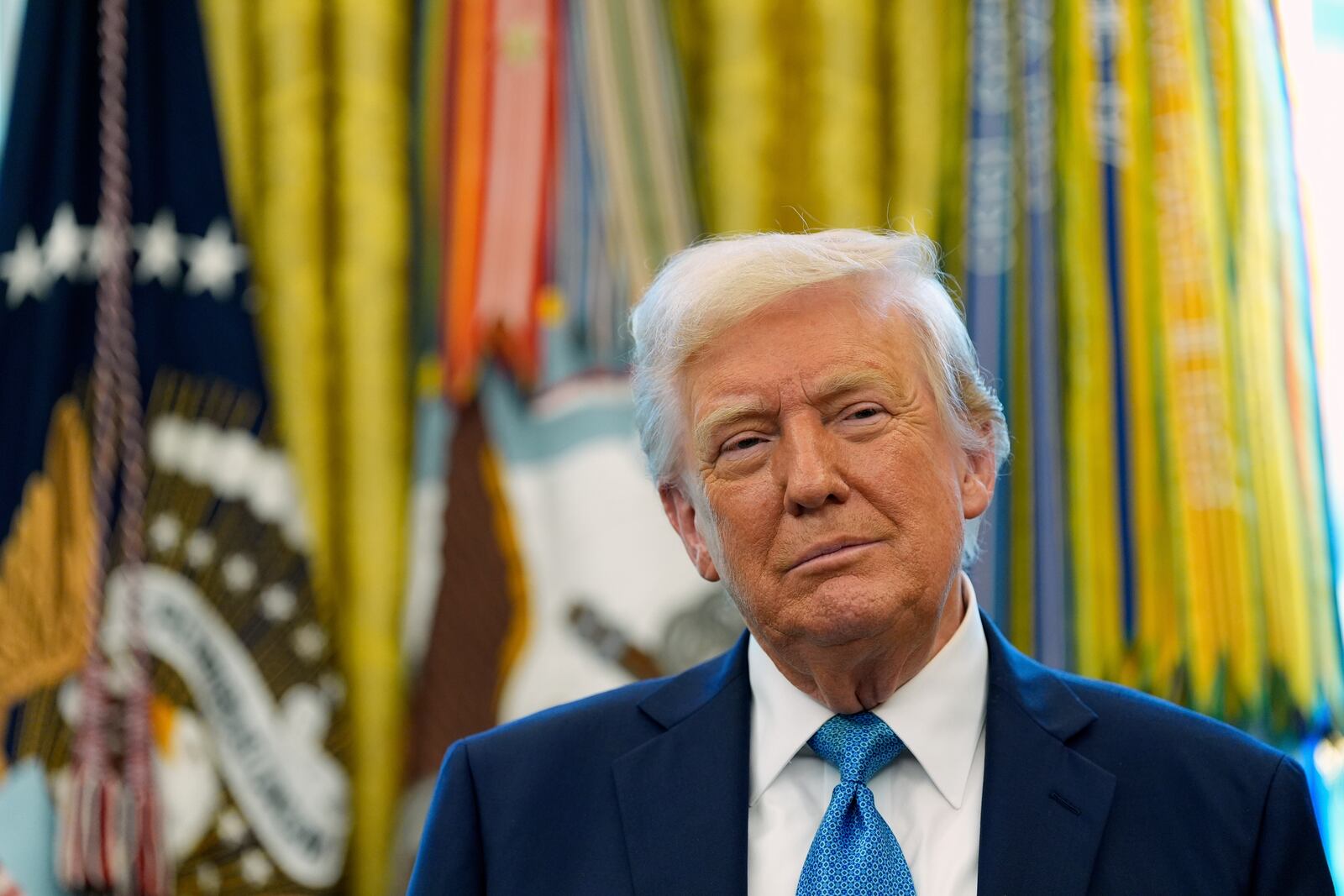 President Donald Trump watches as Treasury Secretary Scott Bessent participates in a ceremonial swearing in of Paul Atkins as chairman of the Securities and Exchange Commission, in the Oval Office of the White House, Tuesday, April 22, 2025, in Washington. (AP Photo/Alex Brandon)