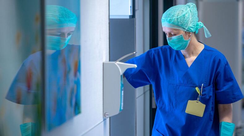 FILE PHOTO: Health care professionals who are facing a shortage of surgical masks and are on the front lines of the coronavirus pandemic know the importance of how to properly wear and remove personal protective equipment.