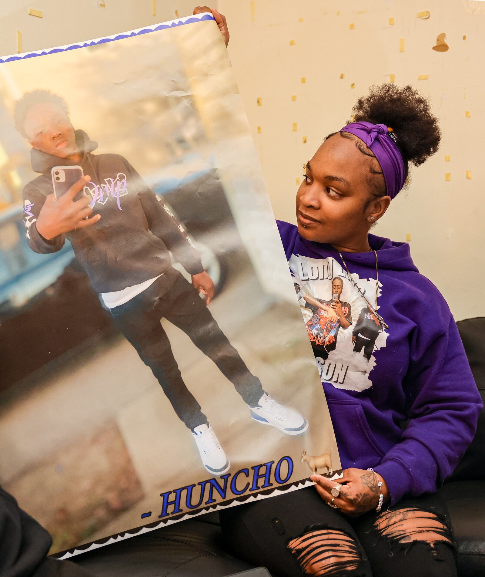 Tierra Stark looks at a poster of Hillary Farr Jr., who was killed outside of his West Dayton home in September. Hillary was respectful, kind, generous, beloved by the kids in the neighborhood and shared whatever he had, according to Stark, his mother. BRYANT BILLING/STAFF