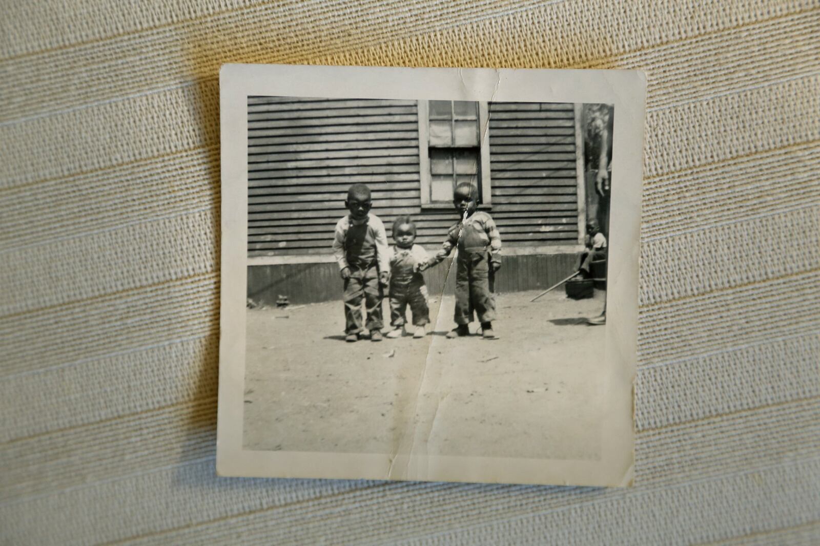 Nathaniel Lee Scott of Dayton celebrated his 100th birthday in March. Scott, at left in this photograph taken when he was 4-years-old with two of his brothers, will throw out the first pitch at an upcoming Dayton Dragons game. LISA POWELL / STAFF