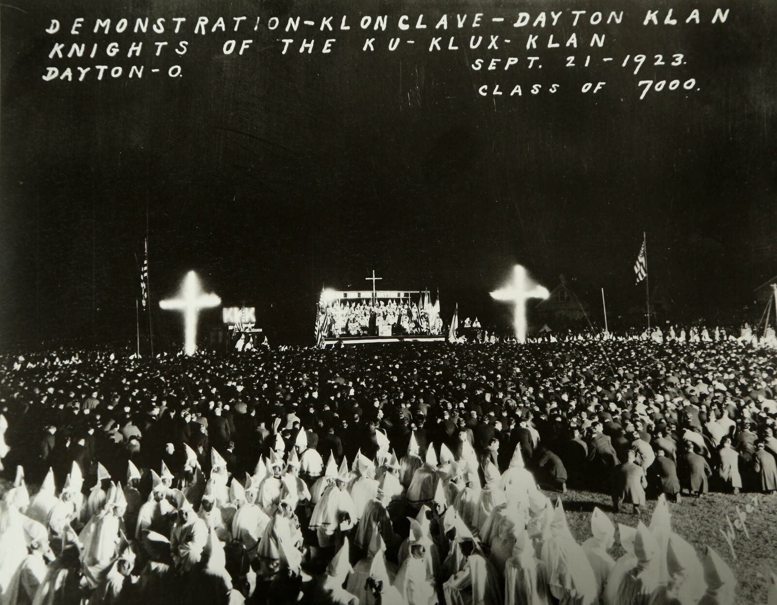 On Sept. 21, 1923, after a parade through the downtown that had sidewalks packed with cheering spectators, Klan held a “naturalization ceremony, at Fairgrounds. Some 15,000 members, were joined by some 7,000 initiates from around the state as 10,000 spectators watched from the grandstand. A 100-foot high cross was set ablaze, there was a fireworks display and overhead a Klan plane circled with a red cross in electric lights on its side. In this time, the target of the Klan – even more so than the immigrants who had come to town to work at NCR and Delco – was the University of Dayton and its “Catholics.” The Klan burned numerous crosses on UD property and harassed students. COPIED FROM A PHOTO (UD history professor Dr. William Vance Trollinger Jr.) OBTAINED FROM THE DAYTON METRO LIBRARY