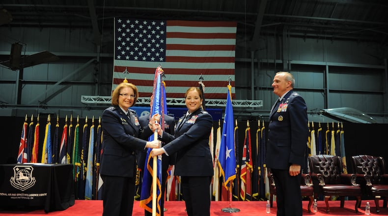 Col. Ariel G.  Batungbacal (center) takes command of the National Air and Space Intelligence Center after receiving the guidon from Lt. Gen. Mary F. O’Brien, Deputy Chief of Staff for Intelligence, Surveillance, Reconnaissance and Cyber Effects Operations (left) in June 2022. U.S. Air Force photo / Senior Airman Kristof J. Rixmann