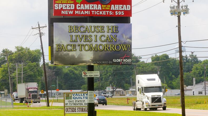 A billboard warns motorists of the speed cameras set up in New Miami. GREG LYNCH/2013