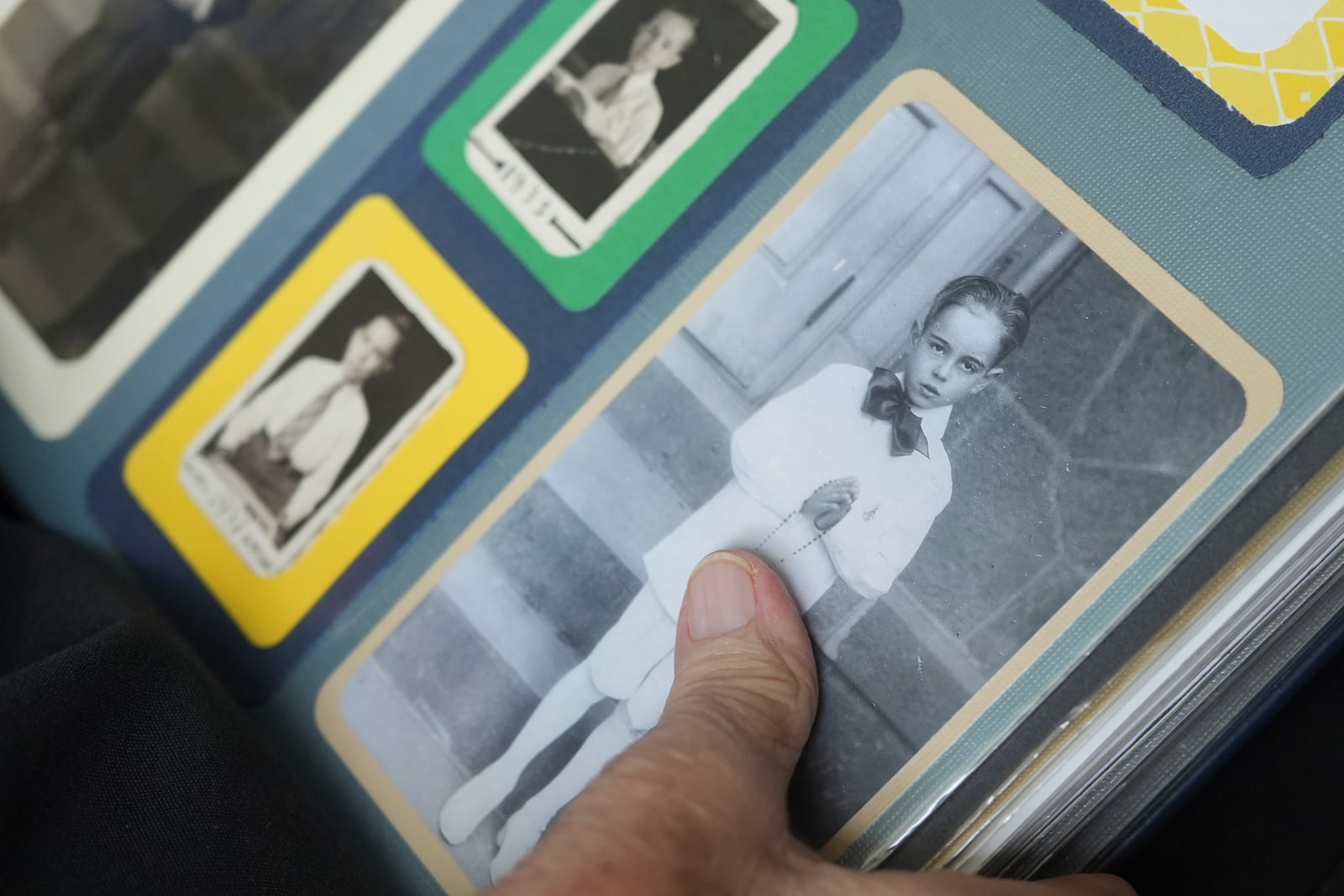 The Rev. James Kelly points to a portrait of himself during his First Communion during an interview at the Normandy Farms Estates retirement community in Blue Bell, Pa., on Wednesday, June 18, 2025. (AP Photo/Luis Andres Henao)