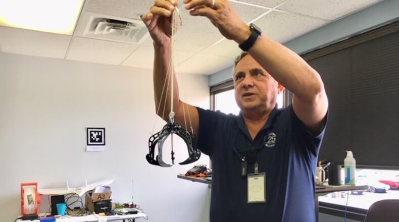 Engineer Ben Bosma, tinkering in his Col Glenn Highway office at MTSI Inc. THOMAS GNAU/STAFF