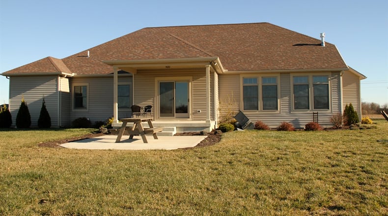 A patio door off the breakfast room opens to the covered rear porch with concrete patio extension.