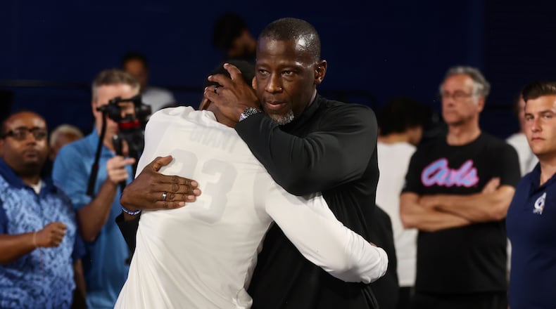 Dayton's Anthony Grant hugs his son Makai Grant after a victory against Florida Atlantic in the first round of the NIT on Wednesday, March 19, 2025, at Baldwin Arena in Boca Raton, Fla. David Jablonski/Staff