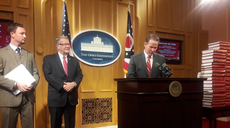 Lt. Gov. Jon Husted (right) announces a bill to trim "outdated and unnecessary" regulations on Dec. 14, 2021. Bill sponsors will be state Rep. Thomas Hall, R-Madison Twp., (left) and Sen. Steve Wilson, R-Maineville. Jim Gaines/STAFF