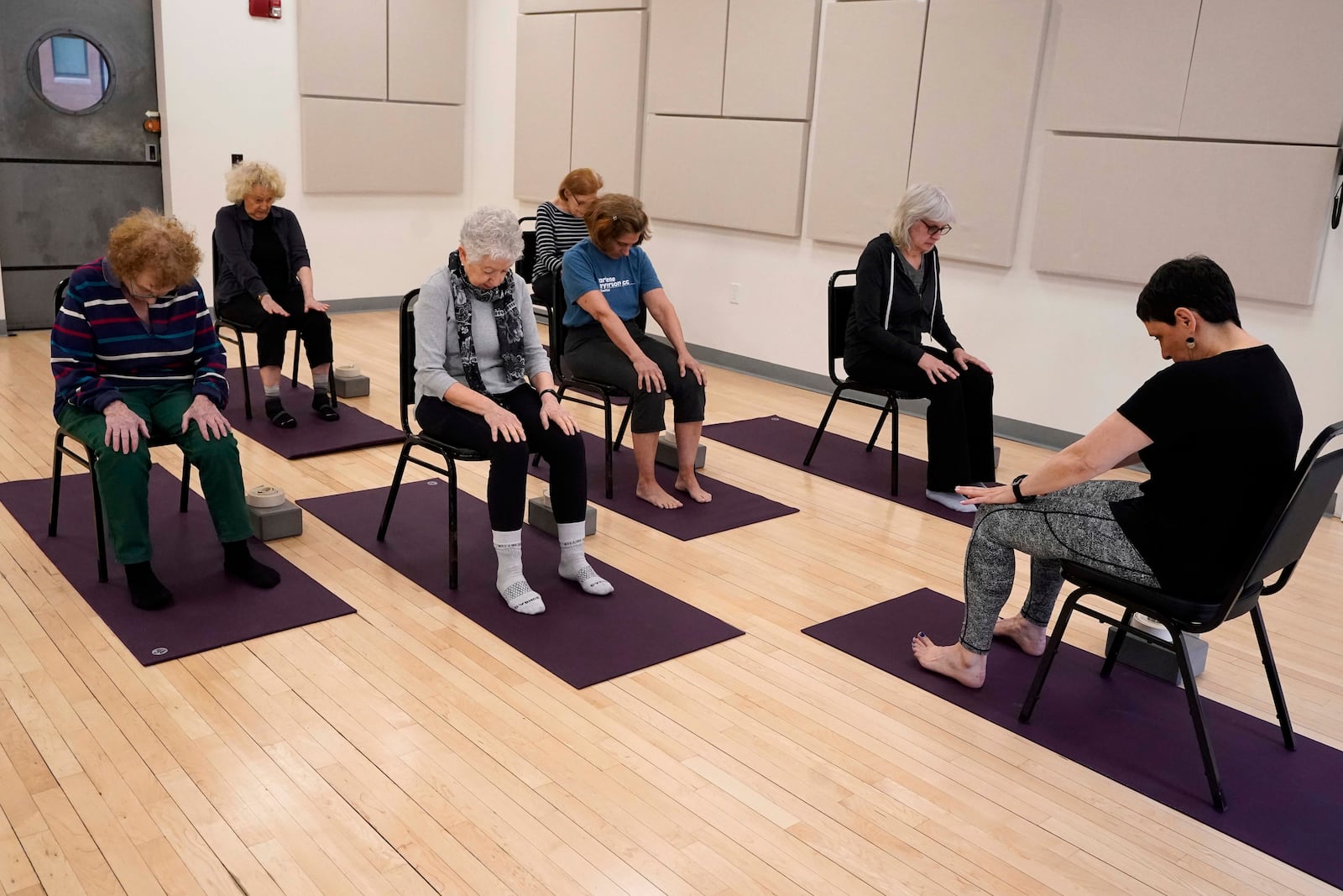 Whitney Chapman, right, conducts a chair yoga class at the Marlene Meyerson JCC Manhattan, in New York, March 28, 2025. (AP Photo/Richard Drew)