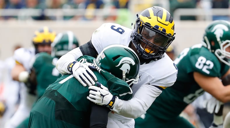 EAST LANSING, MI - OCTOBER 29: Mike McCray #9 of the Michigan Wolverines sacks quarterback Tyler O’Connor #7 of the Michigan State Spartans during the second quarter of the game at Spartan Stadium on October 29, 2016 in East Lansing, Michigan. (Photo by Leon Halip/Getty Images)