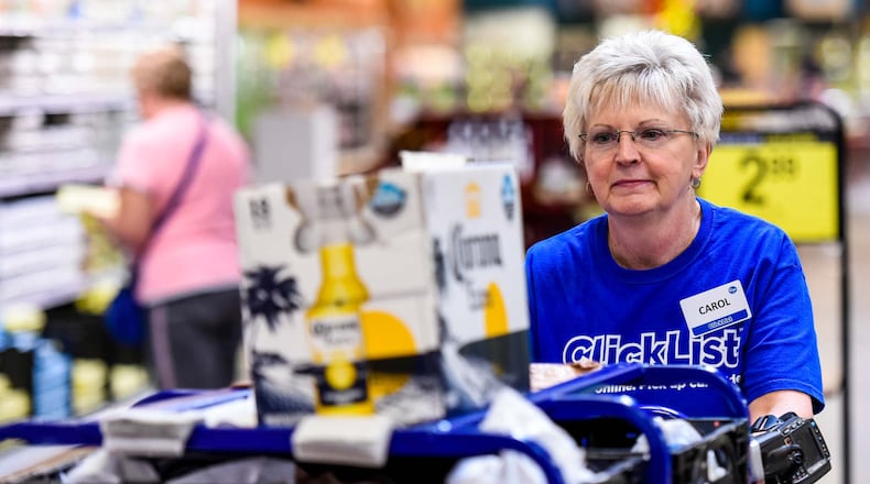 Carol Spencer collects an online grocery order for the Clicklist store pickup Thursday, Sept. 8 at Kroger Marketplace on Yankee Road in Liberty Township. Customers can order their groceries online and pay and get their order loaded into their car by Kroger staff. NICK GRAHAM/STAFF