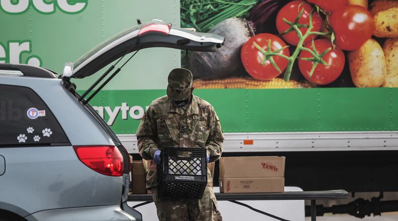 Springfield National Guardsman, Jason Wright loads a car with food at the Living Word Church in Vandalia Wednesday March 10, 2021.