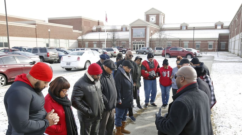 Pastors, parents, elected officials and community members held a prayer rally at Trotwood-Madison High School on March 1, 2019, in response to fights and subsequent arrests that took place at the school. TY GREENLEES / STAFF