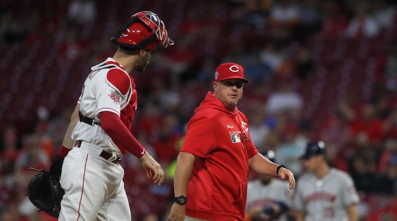Reds pitch coach Derek Johnson, right, talks to catch Curt Casali after a mound visit during a game against the Astros on Monday, June 17, 2019, at Great American Ball Park in Cincinnati. David Jablonski/Staff