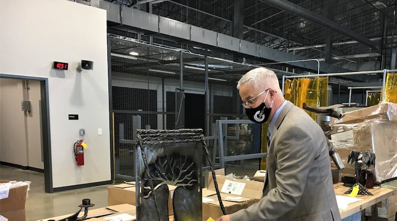 Greene County Career Center Superintendent Dave Deskins shows off some students' welding work. STAFF/BONNIE MEIBERS