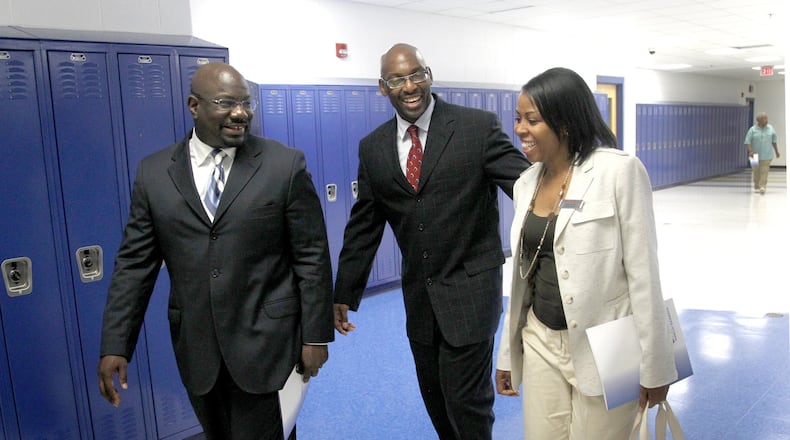 In this file photo, Larry Ballew (left), then dean of Dunbar High School, gives a tour to Angela Davis (right), a school community partner from Office Depot along with David Lawrence (center), then chief of school innovation at Dayton Public Schools. LISA POWELL / STAFF