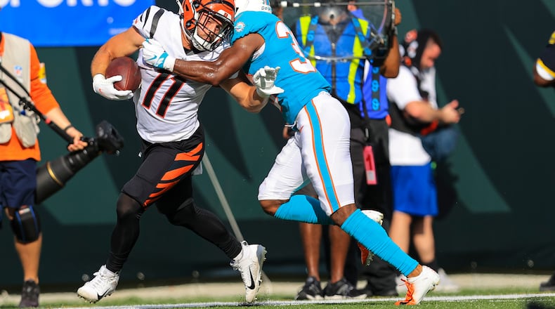 Cincinnati Bengals wide receiver Trent Taylor (11) is tackled by Miami Dolphins cornerback Jamal Perry (33) in the second half of an NFL exhibition football game in Cincinnati, Sunday, Aug. 29, 2021. (AP Photo/Aaron Doster)