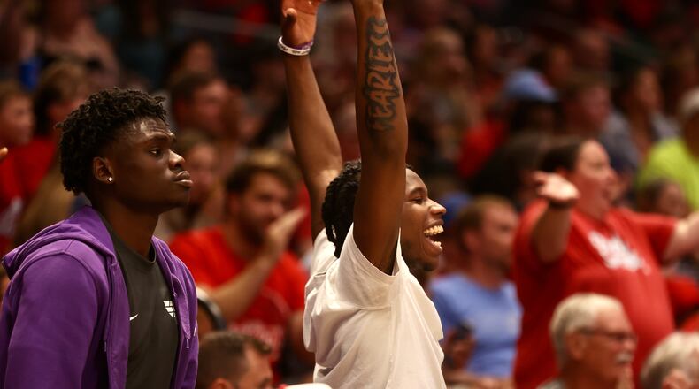 Dayton's Enoch Cheeks, left, and Malachi Smith cheer on the Red Scare during a game against India Rising in the first round of The Basketball Tournament on Wednesday, July 26, 2023, at UD Arena in Dayton. David Jablonski/Staff