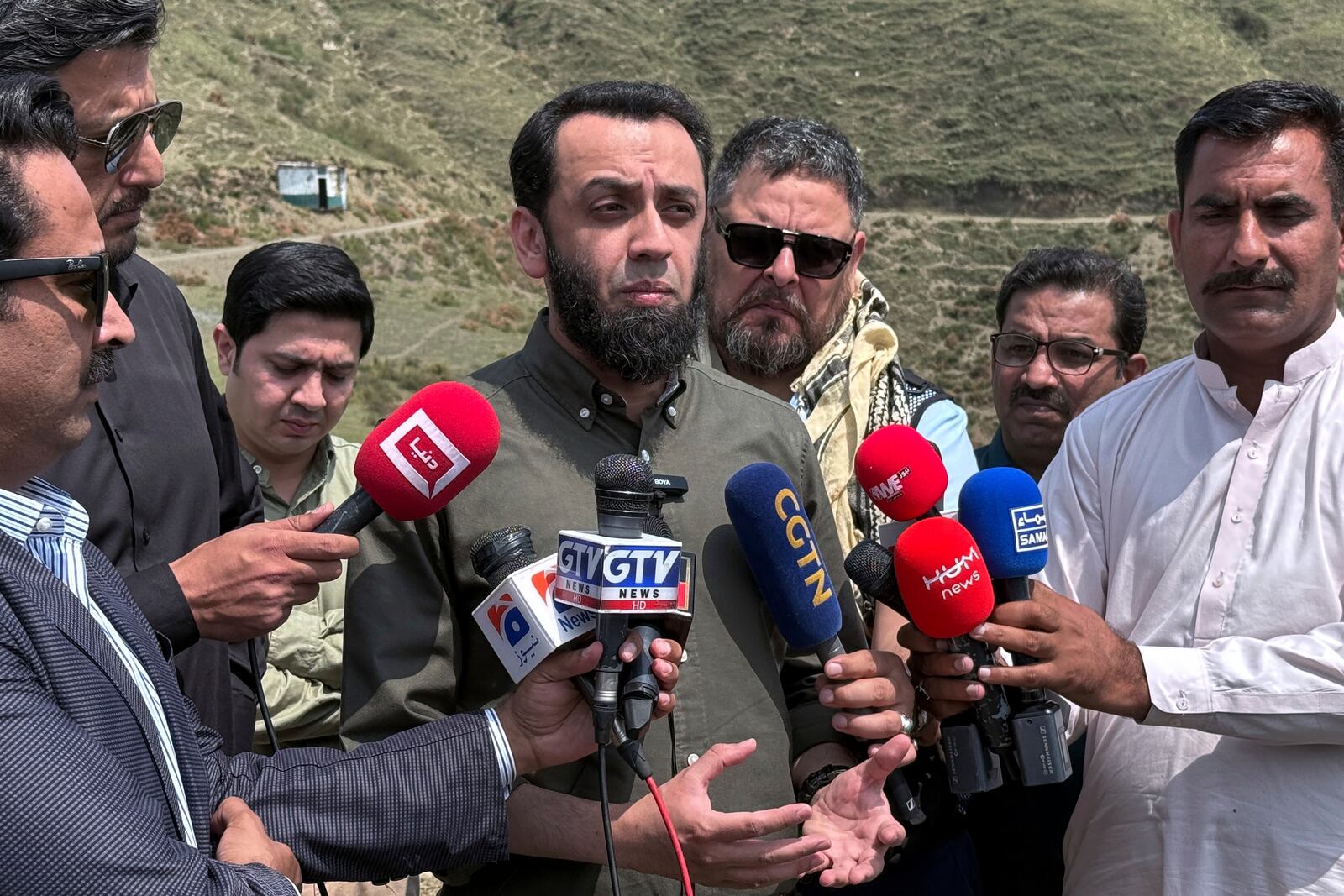 Pakistan's Information Minister Attaullah Tarar, center, briefs journalists during a government's organised trip for media to Bella Noor Shah, a mountainous village near Muzaffarabad, the capital of Pakistan administered Kashmir, Monday, May 5, 2025. (AP Photo/Muhammad Yousuf, Pool)