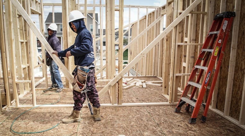 Construction crews frame up a new house in the Lexington Place development in Huber Heights Thursday April 15,2021.